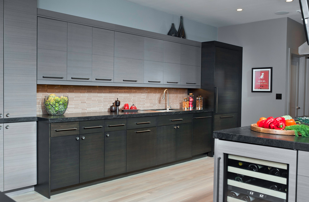 This is an example of a large contemporary galley separate kitchen in Chicago with an undermount sink, flat-panel cabinets, grey cabinets, granite benchtops, brown splashback, matchstick tile splashback, stainless steel appliances, light hardwood floors, no island and beige floor.