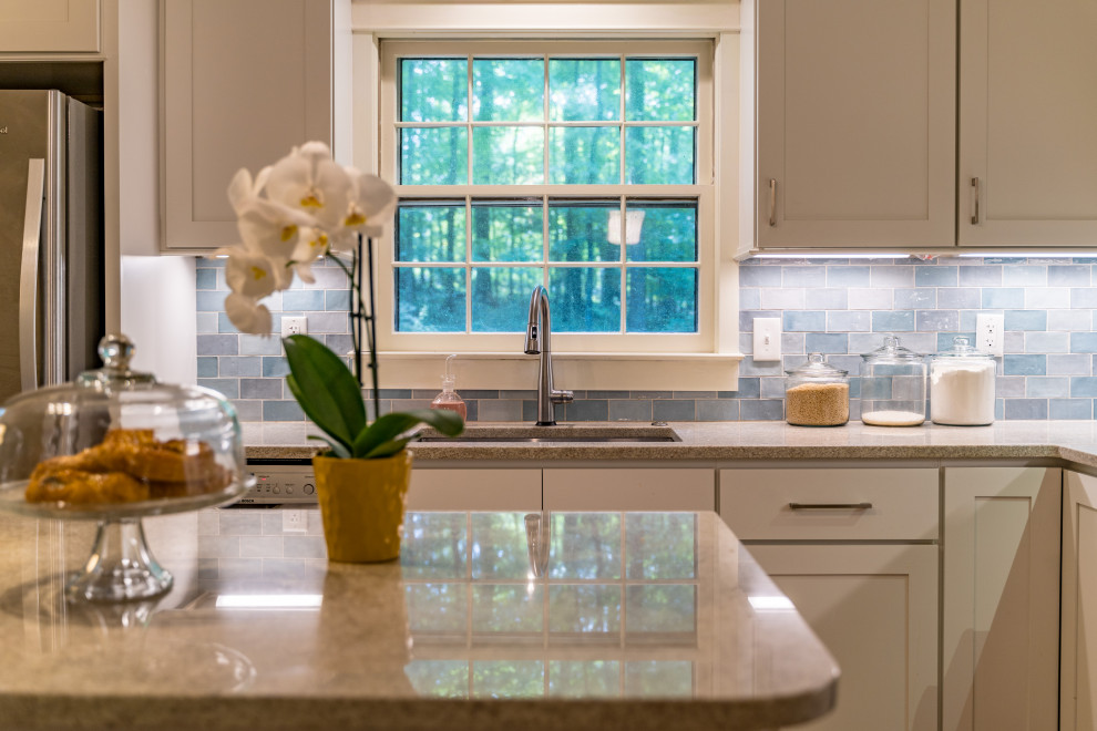 Inspiration for a mid-sized transitional l-shaped medium tone wood floor eat-in kitchen remodel with shaker cabinets, white cabinets, granite countertops, blue backsplash, ceramic backsplash, stainless steel appliances, an island and beige countertops