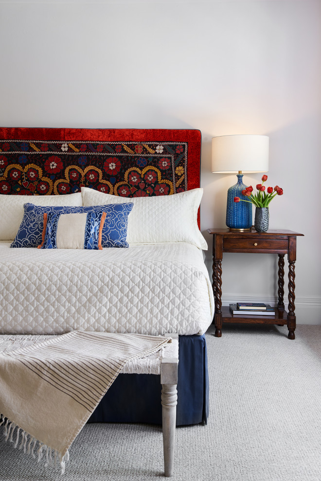Inspiration for a mediterranean guest bedroom in Austin with white walls and carpet.