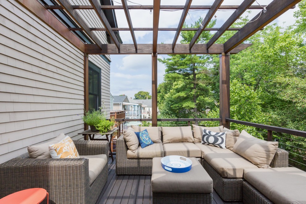 This is an example of a mid-sized transitional backyard verandah in Boston with a pergola.