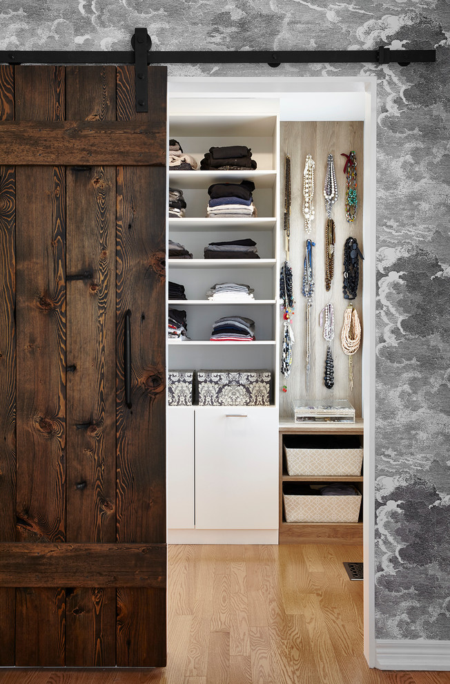 Design ideas for a country women's walk-in wardrobe in Toronto with open cabinets.