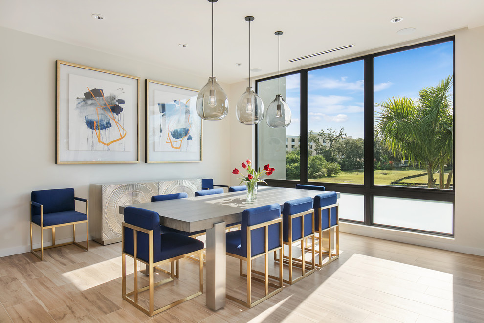 Mid-sized contemporary open plan dining in Tampa with white walls, porcelain floors and brown floor.