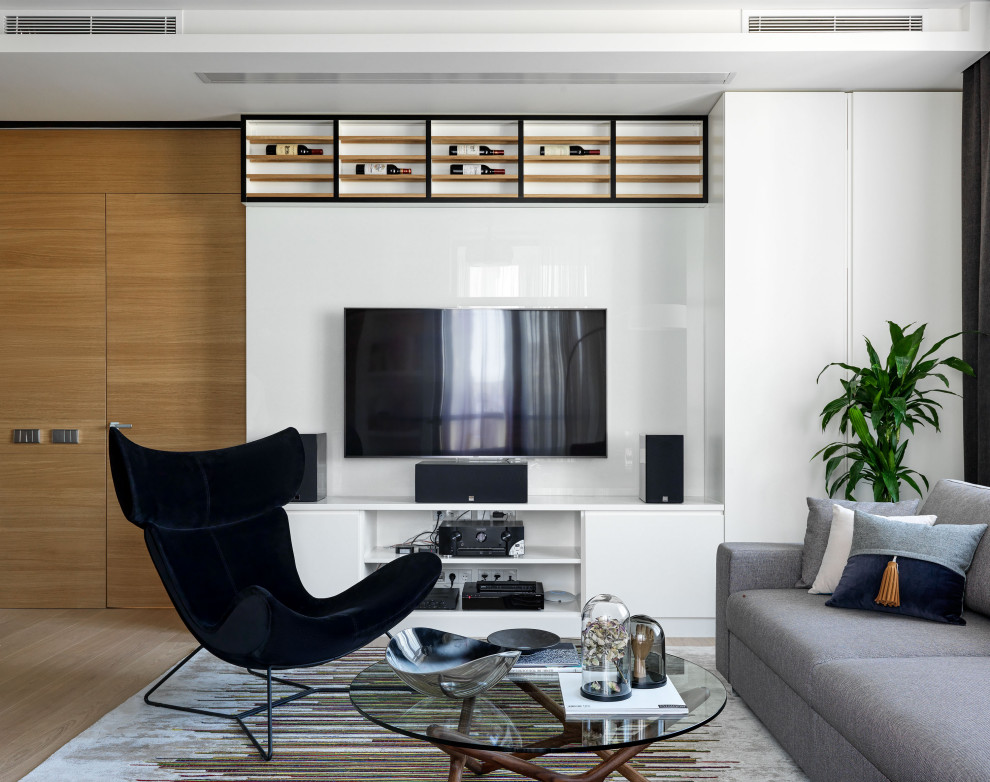 Photo of a contemporary living room in Moscow with white walls, a wall-mounted tv and beige floor.