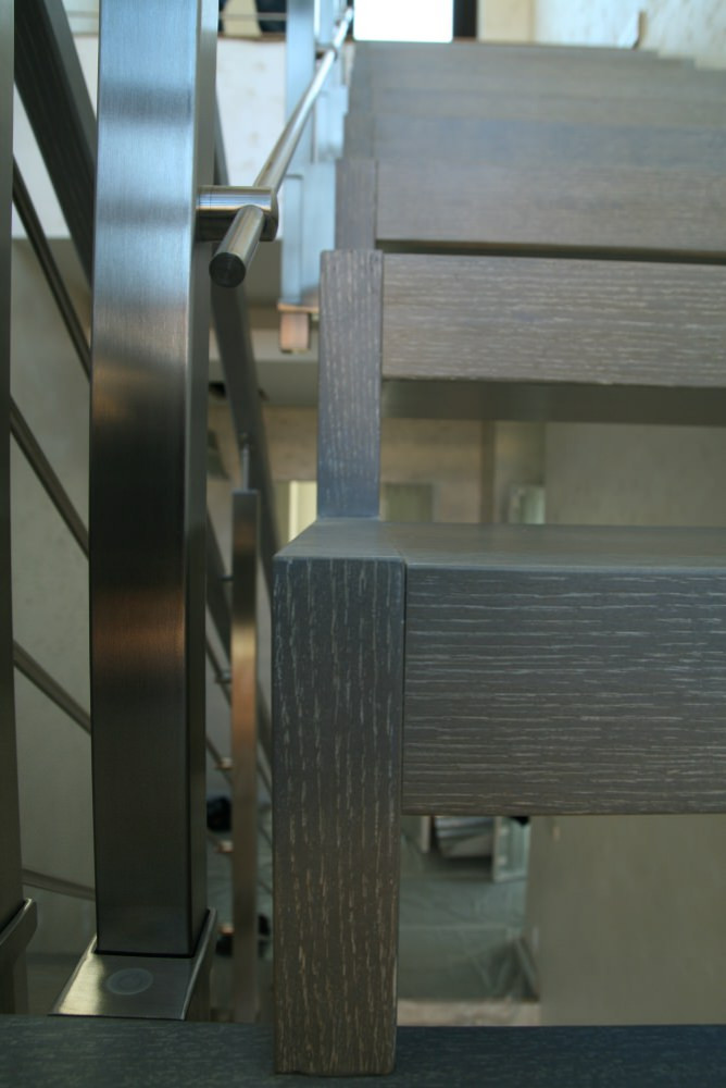 Modern metal stair covered by patina oak