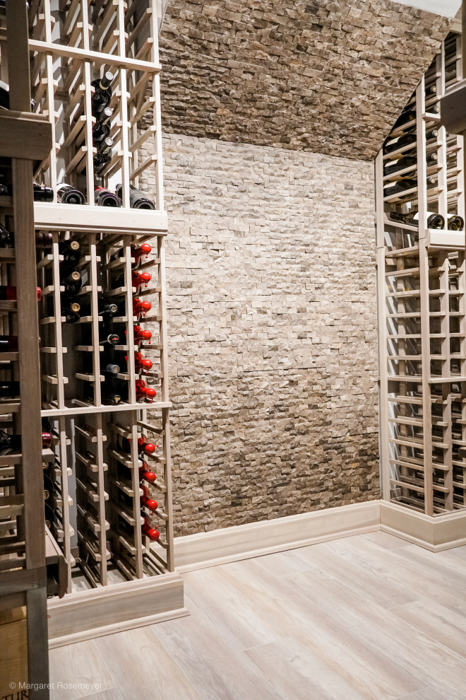 Photo of a small transitional wine cellar in Chicago with laminate floors, diamond bins and grey floor.