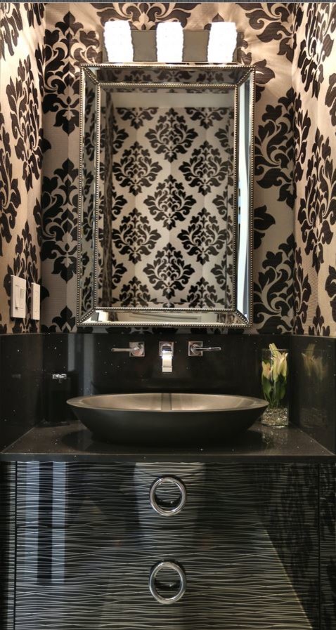 Photo of a small contemporary powder room in Toronto with a vessel sink, flat-panel cabinets, black cabinets, granite benchtops, a two-piece toilet, white tile, porcelain tile, porcelain floors and black benchtops.