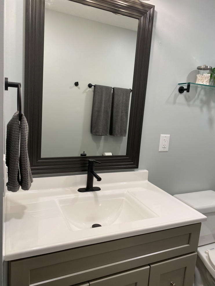 Example of a large transitional l-shaped vinyl floor and gray floor open concept kitchen design in Cincinnati with an undermount sink, raised-panel cabinets, white cabinets, granite countertops, multicolored backsplash, ceramic backsplash, stainless steel appliances, an island and black countertops