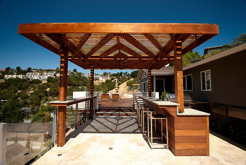 This is an example of a large contemporary backyard deck in San Francisco with a pergola.
