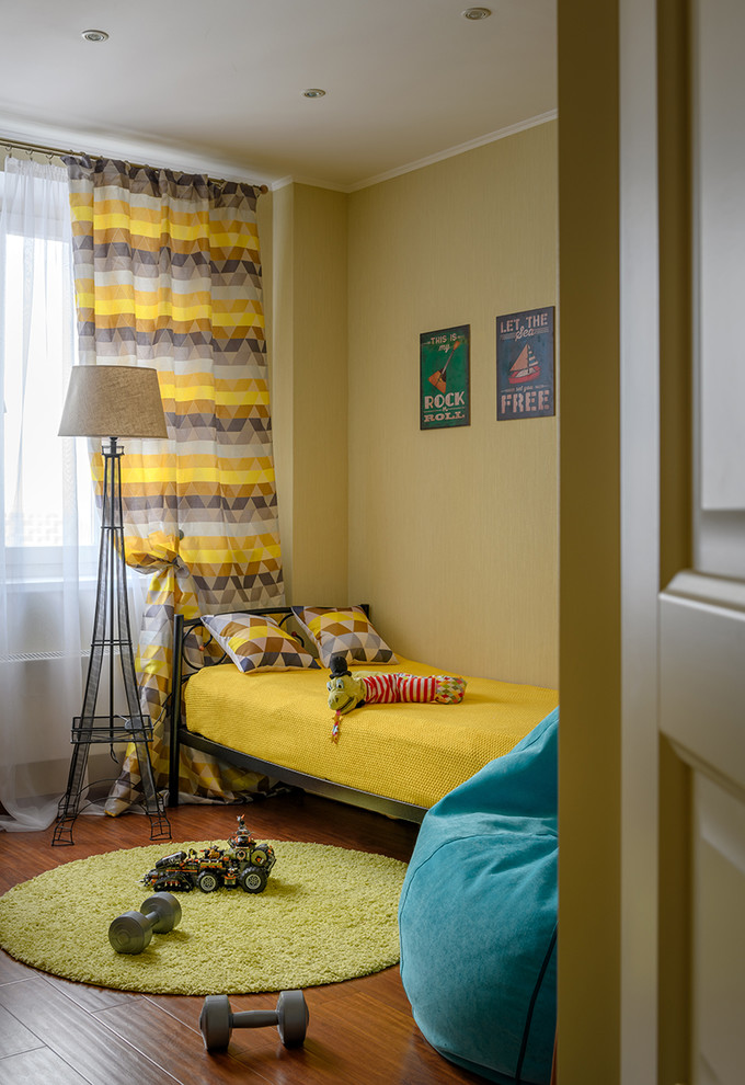Design ideas for a small transitional kids' playroom for kids 4-10 years old and boys in Moscow with yellow walls, laminate floors and brown floor.