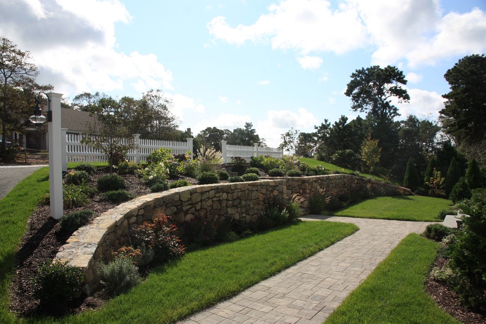 Photo of a traditional garden in Boston with natural stone pavers.