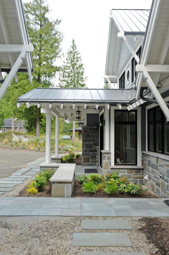 This is an example of a transitional garden in Vancouver with natural stone pavers.