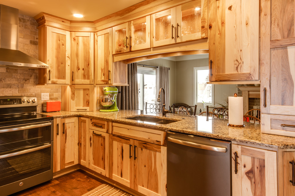 Inspiration for a country u-shaped eat-in kitchen in Detroit with an undermount sink, shaker cabinets, light wood cabinets, quartzite benchtops, beige splashback, subway tile splashback and stainless steel appliances.