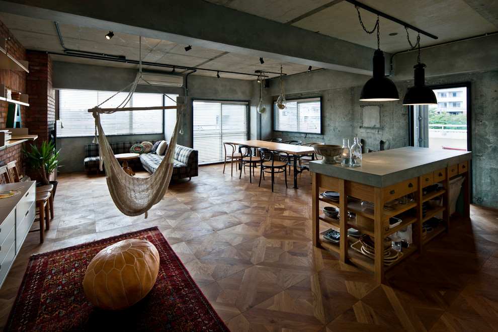 Photo of an industrial family room in Tokyo with grey walls, medium hardwood floors and brown floor.
