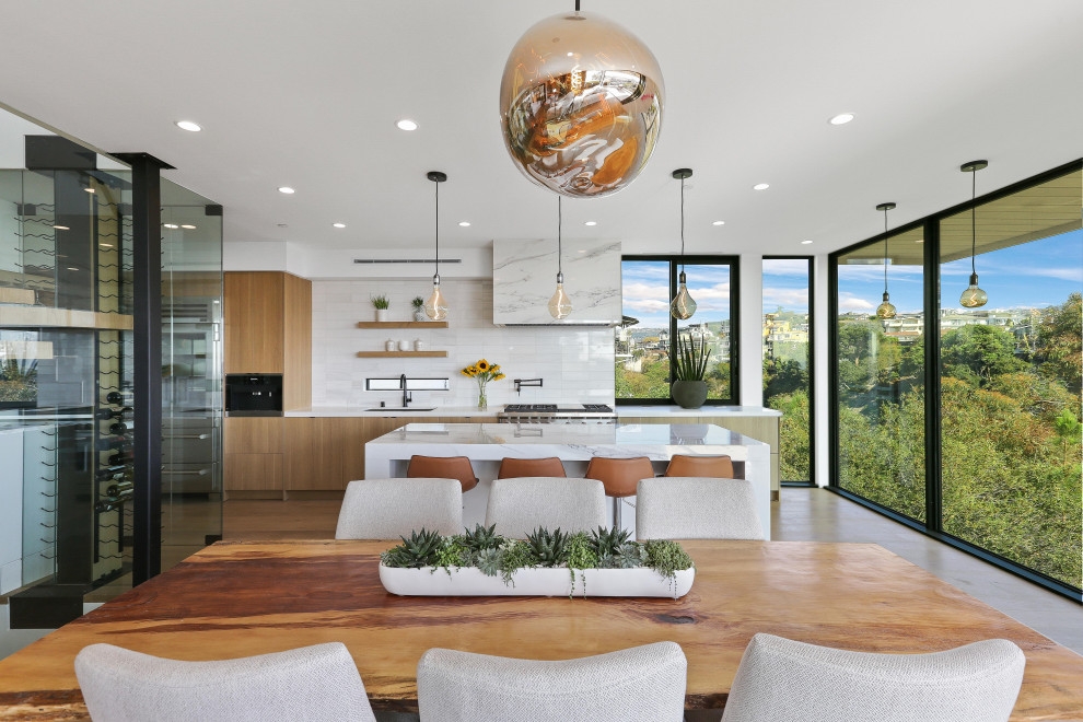 Inspiration for an expansive contemporary open plan dining room in Los Angeles with white walls, medium hardwood flooring, no fireplace, brown floors and a stone fireplace surround.