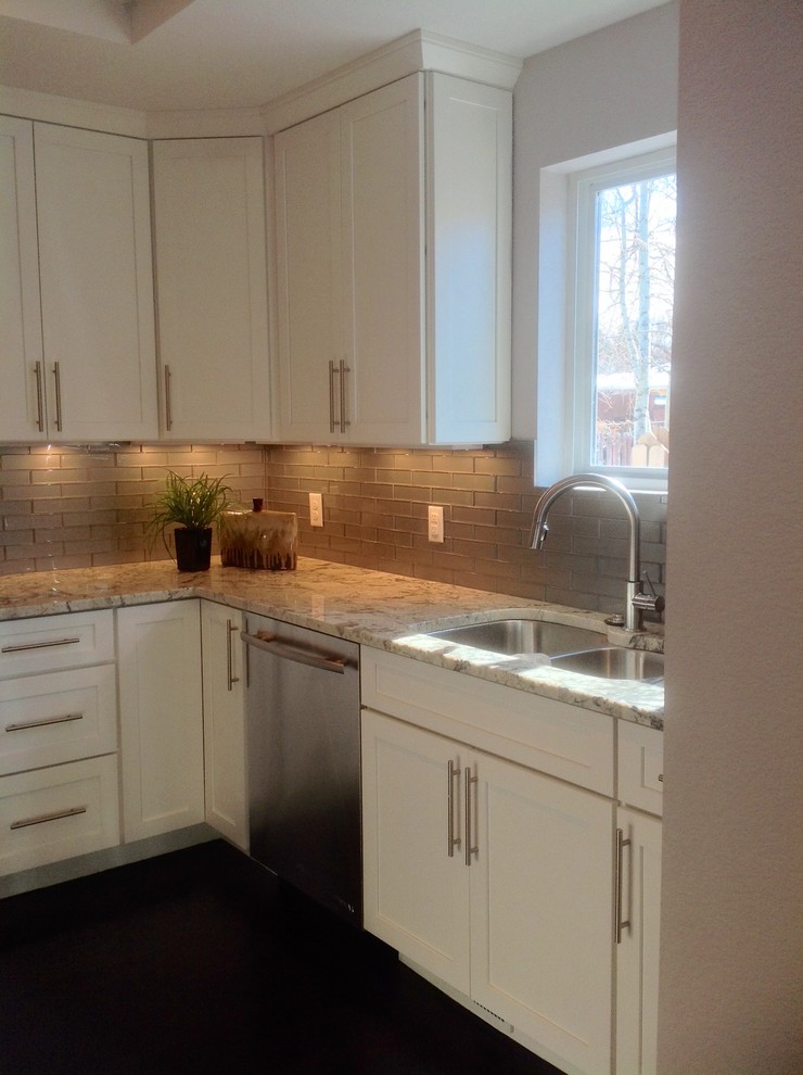Mid-sized transitional galley dark wood floor eat-in kitchen photo in Denver with a double-bowl sink, recessed-panel cabinets, white cabinets, granite countertops, gray backsplash, ceramic backsplash, stainless steel appliances and an island