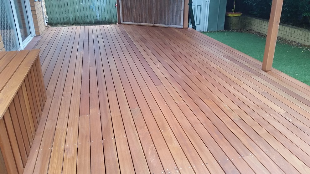 This is an example of a small modern backyard deck in Sydney.