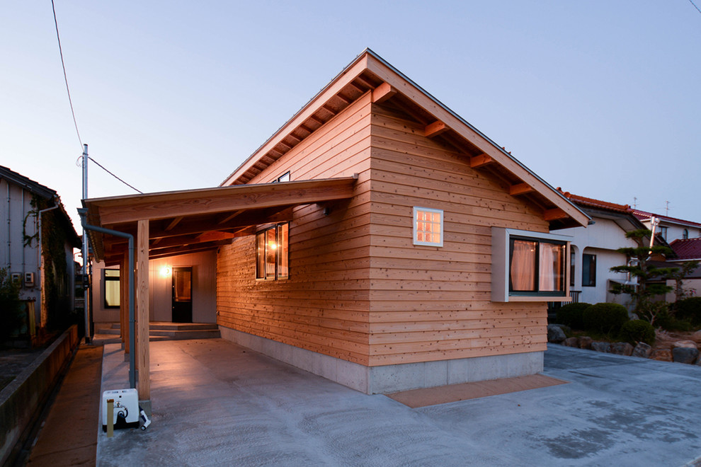 Inspiration for a small asian one-storey beige house exterior in Other with wood siding, a shed roof and a metal roof.