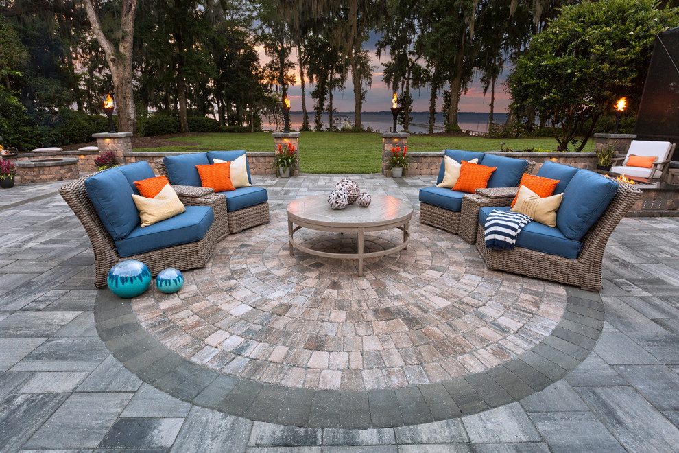 Design ideas for an expansive traditional backyard patio in Jacksonville with a fire feature, natural stone pavers and no cover.