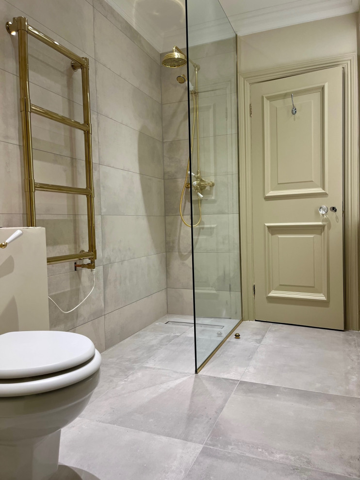Photo of a small contemporary 3/4 wet room bathroom in London with beaded inset cabinets, beige cabinets, a wall-mount toilet, gray tile, porcelain tile, beige walls, porcelain floors, a drop-in sink, marble benchtops, grey floor, an open shower, white benchtops, a laundry, a single vanity, a built-in vanity and recessed.