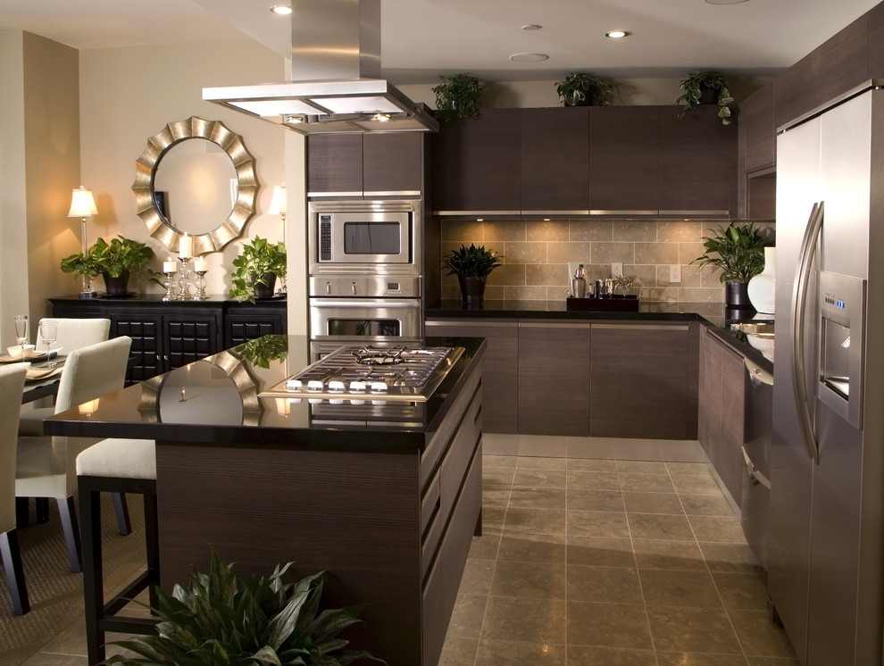 Mid-sized modern l-shaped eat-in kitchen in Dallas with flat-panel cabinets, dark wood cabinets, solid surface benchtops, brown splashback, stone tile splashback, stainless steel appliances, ceramic floors and with island.