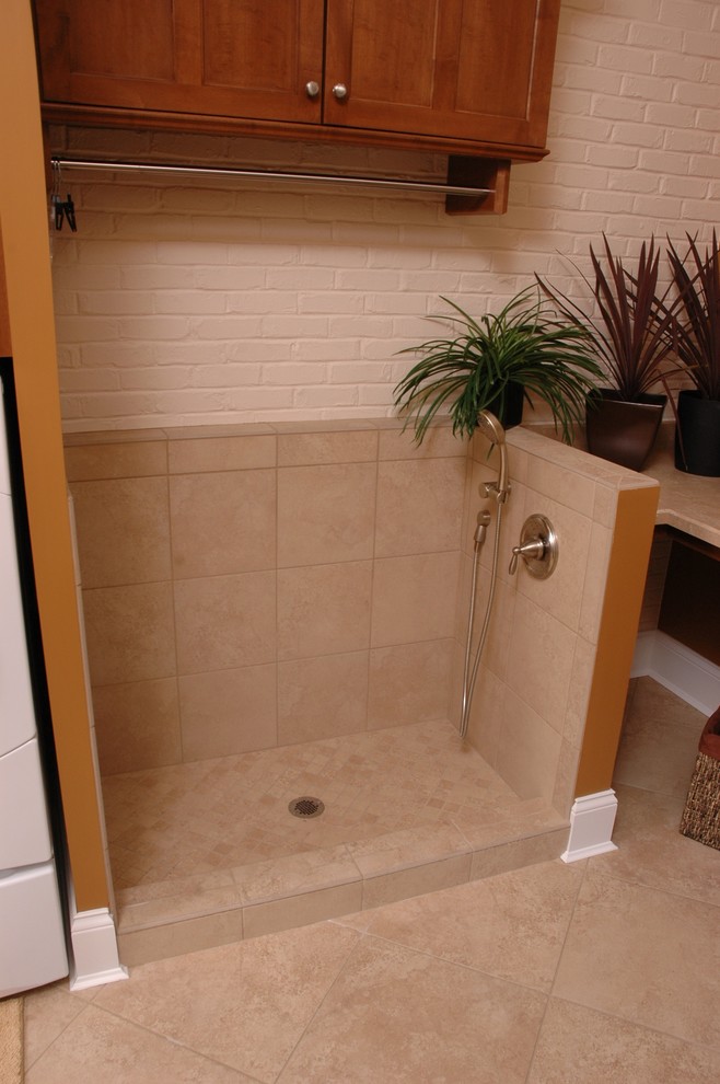 Transitional single-wall linoleum floor home design photo in Cincinnati with a drop-in sink, recessed-panel cabinets, medium tone wood cabinets, laminate countertops, orange walls and a side-by-side washer/dryer