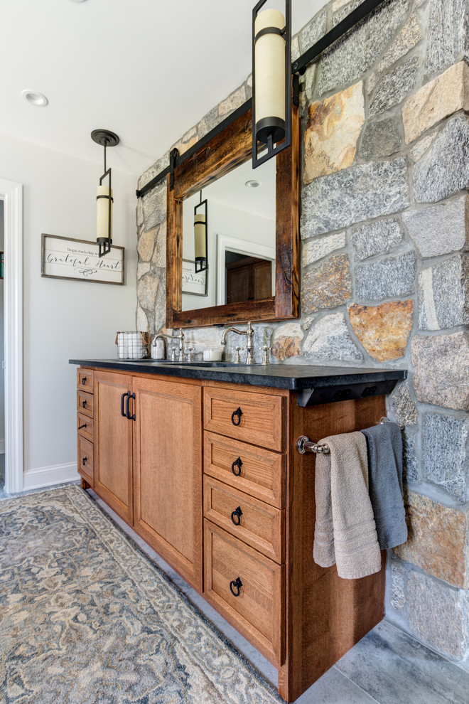 Large country master bathroom in New York with shaker cabinets, light wood cabinets, an open shower, a one-piece toilet, gray tile, cement tile, grey walls, cement tiles, an undermount sink, granite benchtops, grey floor, a sliding shower screen and a claw-foot tub.