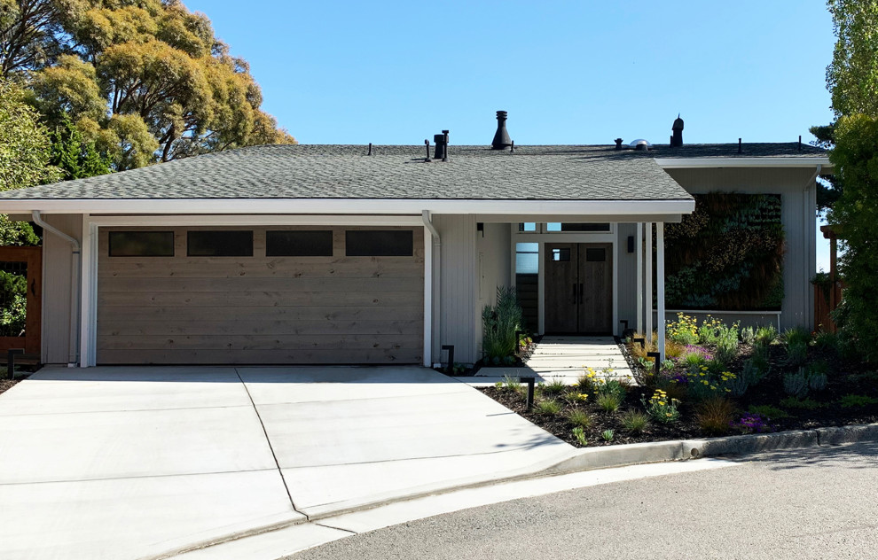 Inspiration for a large midcentury front yard full sun driveway for winter in San Francisco with with path and concrete pavers.