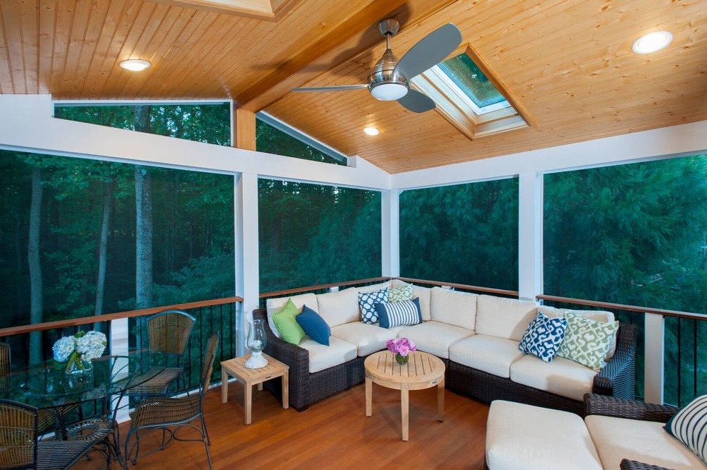 Photo of a large transitional backyard screened-in verandah in DC Metro with decking and a roof extension.