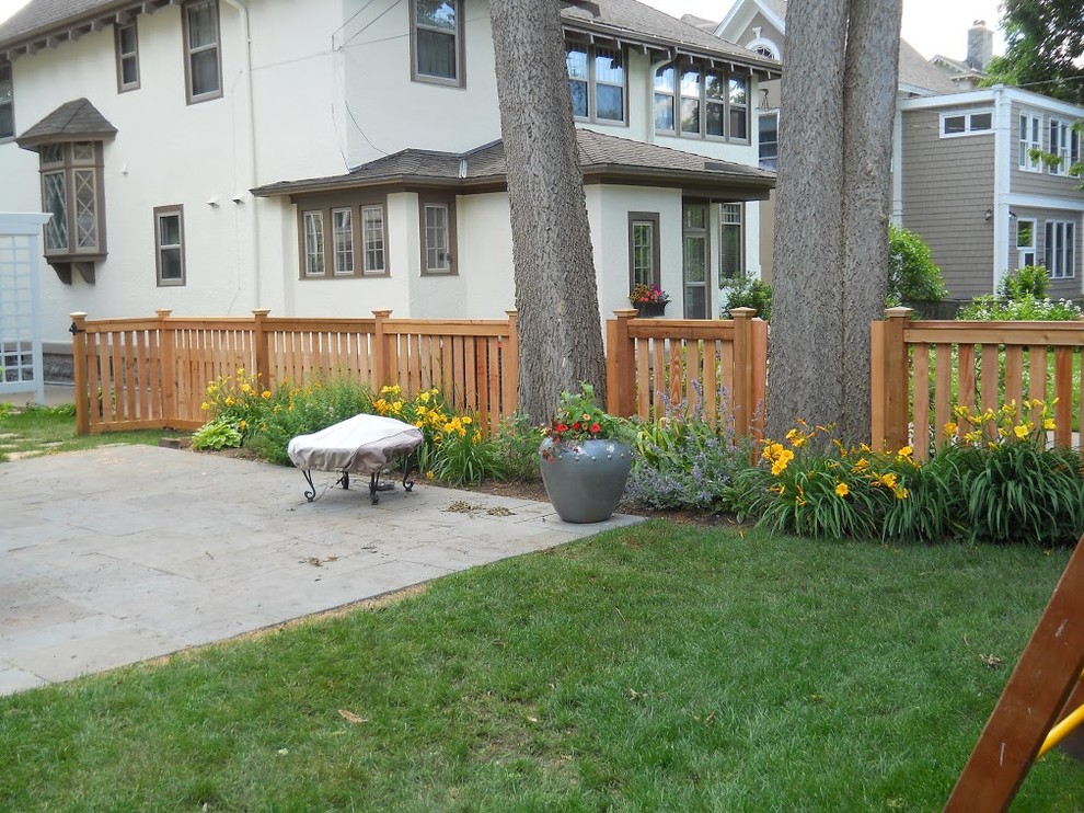 Mid-sized traditional backyard patio in Minneapolis with natural stone pavers and no cover.
