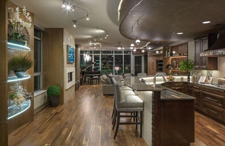 Example of a mid-sized transitional u-shaped medium tone wood floor and brown floor open concept kitchen design in Omaha with an undermount sink, recessed-panel cabinets, dark wood cabinets, granite countertops, a peninsula and brown countertops