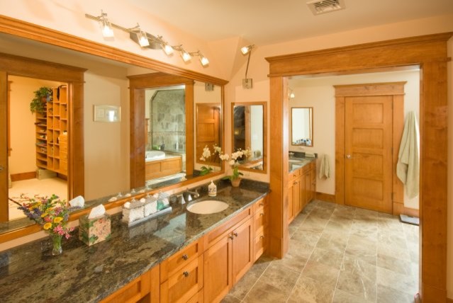Design ideas for a large traditional master bathroom in San Diego with shaker cabinets, medium wood cabinets, ceramic floors, an undermount sink, granite benchtops and grey floor.