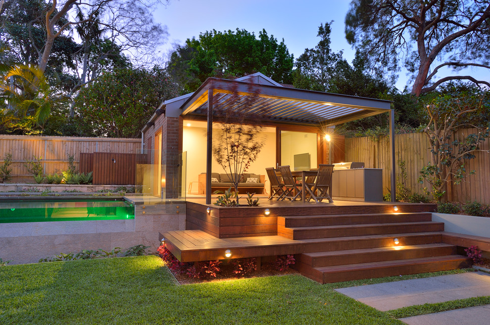 Large contemporary backyard patio in Sydney with a container garden, decking and a gazebo/cabana.