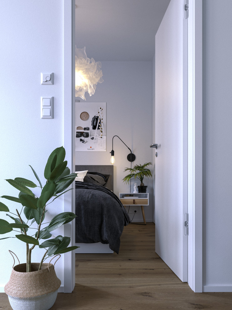 Inspiration for a small scandinavian master bedroom in Other with white walls, medium hardwood floors and brown floor.