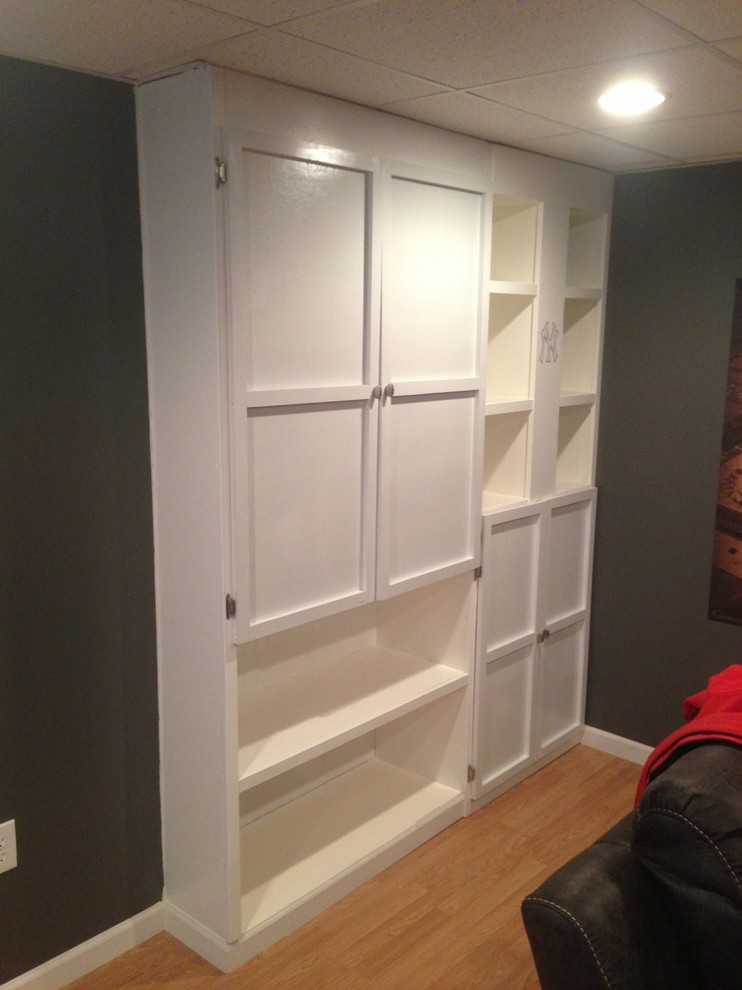 Example of a transitional underground basement design with gray walls