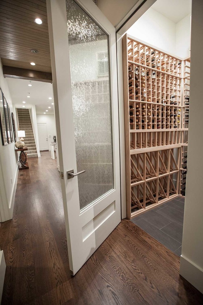 Inspiration for a small traditional wine cellar in Other with storage racks, porcelain floors and black floor.
