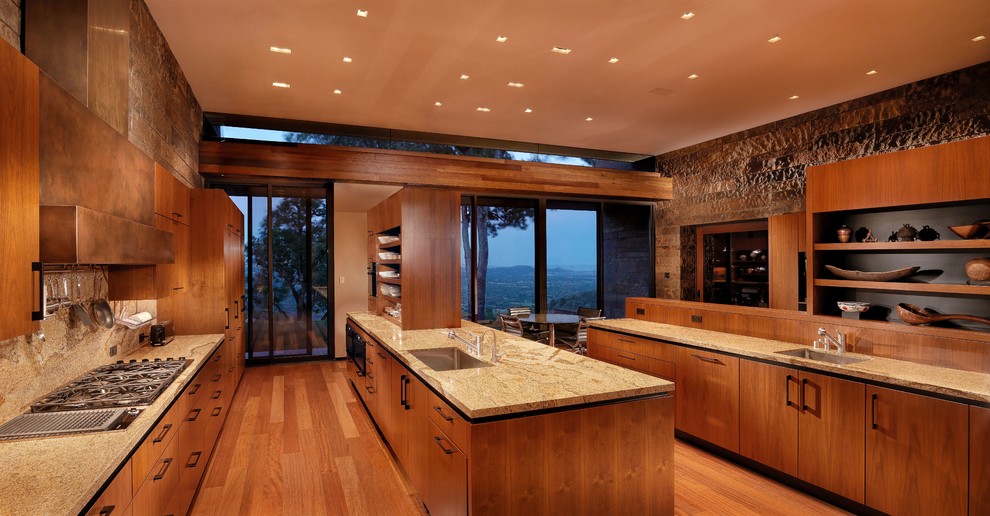 Photo of a contemporary galley kitchen in San Francisco with an undermount sink, flat-panel cabinets, medium wood cabinets, panelled appliances, medium hardwood floors and with island.
