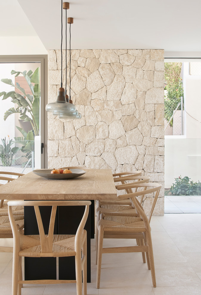 This is an example of a beach style dining room in Palma de Mallorca with beige walls and beige floor.
