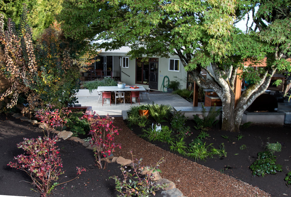 Design ideas for an expansive midcentury backyard patio in Portland with an outdoor kitchen, concrete pavers and a pergola.