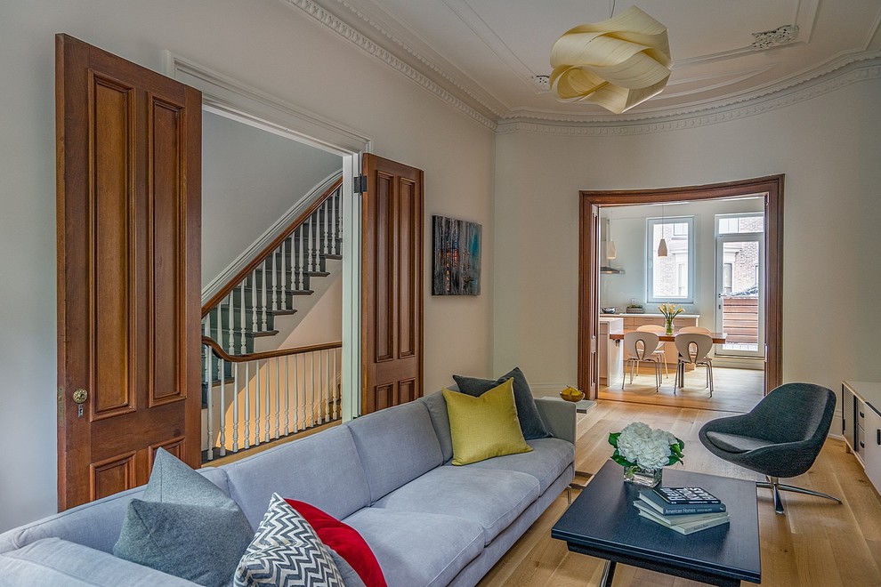Living room - mid-sized transitional formal and enclosed light wood floor living room idea in Boston with white walls, a standard fireplace and no tv