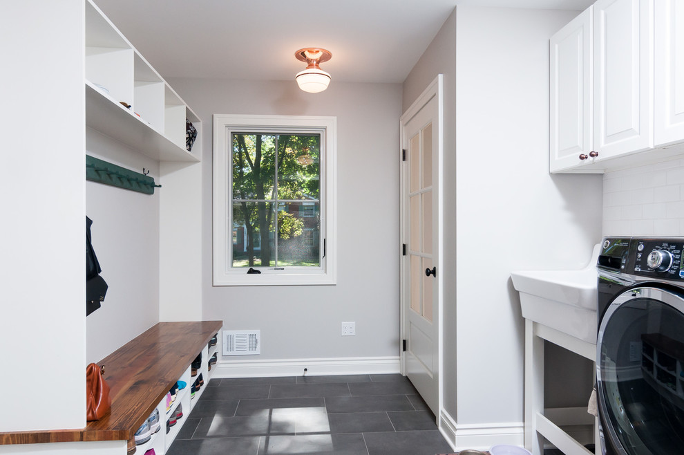 Mudroom - mid-sized transitional light wood floor mudroom idea in Detroit with gray walls