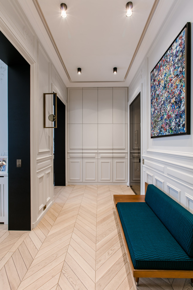 This is an example of a contemporary hallway in Paris with light hardwood floors and beige floor.
