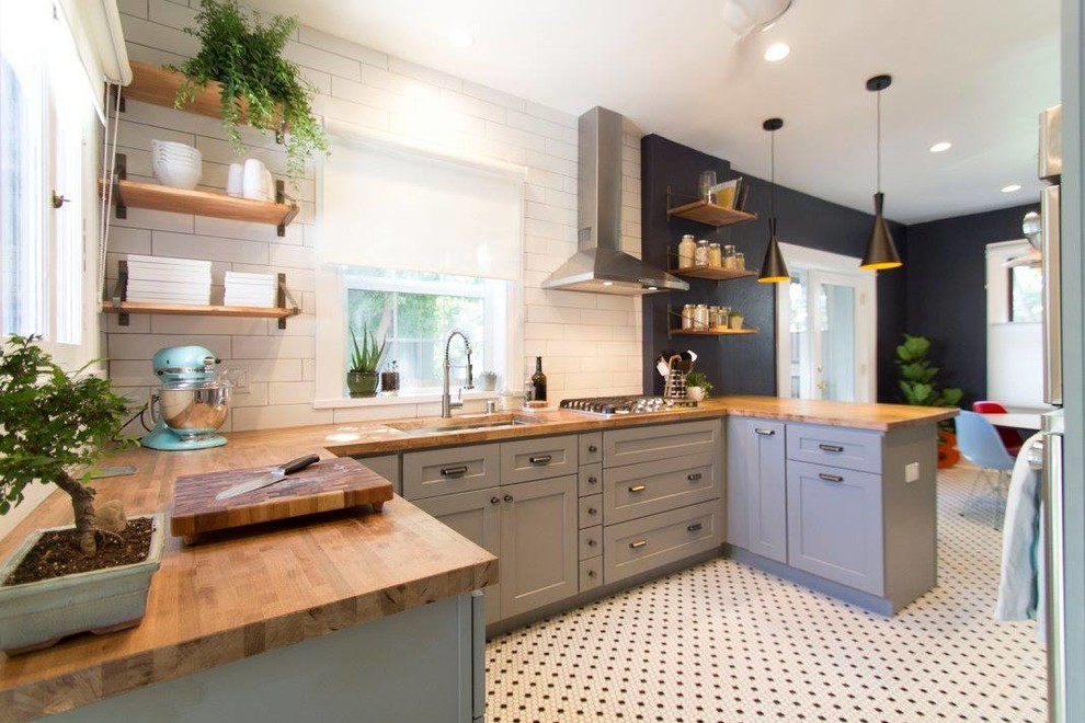 Inspiration for a mid-sized midcentury galley eat-in kitchen in Denver with an undermount sink, shaker cabinets, grey cabinets, wood benchtops, white splashback, ceramic splashback, stainless steel appliances, ceramic floors, a peninsula and white floor.