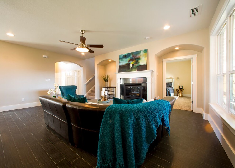 Home design - transitional open concept porcelain tile home design idea in Austin with beige walls, a standard fireplace and a stone fireplace