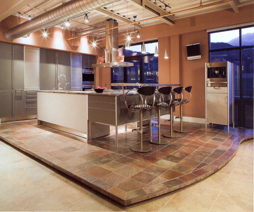 Design ideas for a large industrial l-shaped open plan kitchen in Denver with an undermount sink, flat-panel cabinets, granite benchtops, panelled appliances, slate floors, with island, grey cabinets and multi-coloured floor.