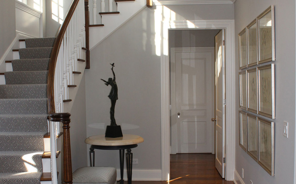 Inspiration for a large transitional dark wood floor foyer remodel in Chicago with gray walls