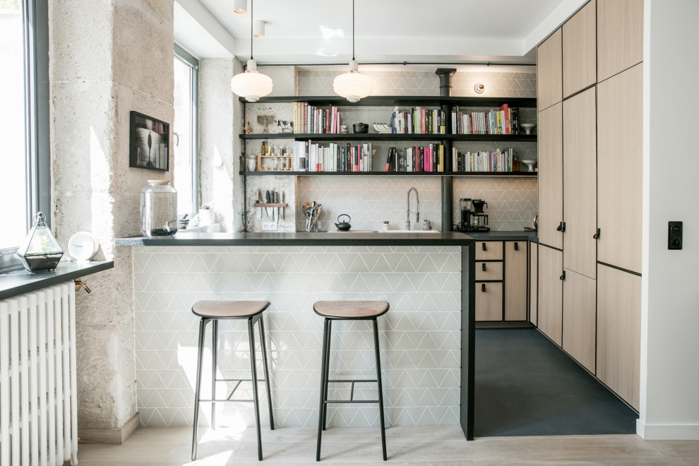 This is an example of a scandinavian l-shaped eat-in kitchen in Paris with an undermount sink, beaded inset cabinets, light wood cabinets, concrete benchtops, green splashback, ceramic splashback, panelled appliances, concrete floors, a peninsula, blue floor and blue benchtop.