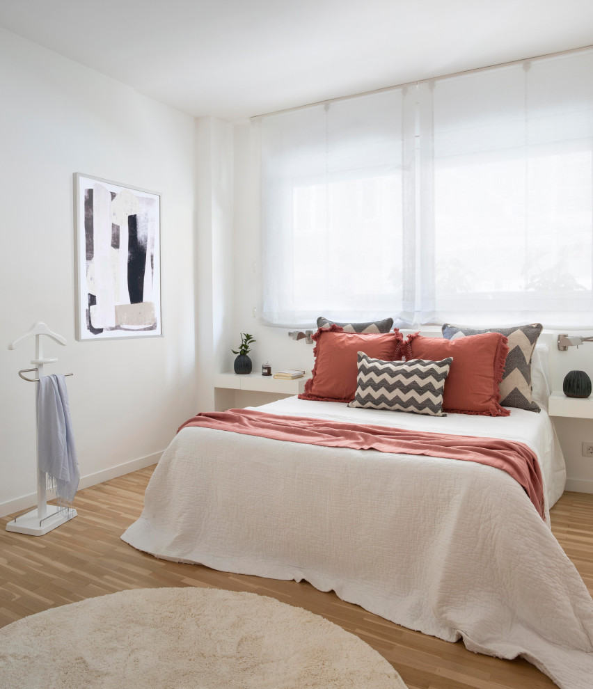 Contemporary master bedroom in Other with white walls and light hardwood flooring.