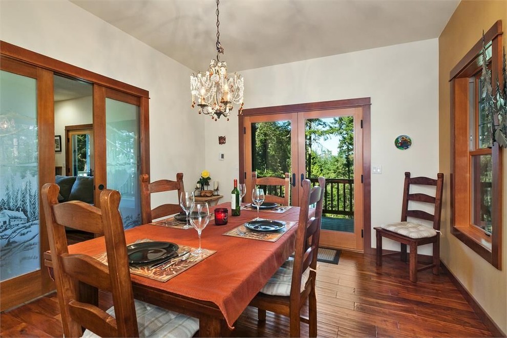 Large medium tone wood floor kitchen/dining room combo photo in Seattle with white walls