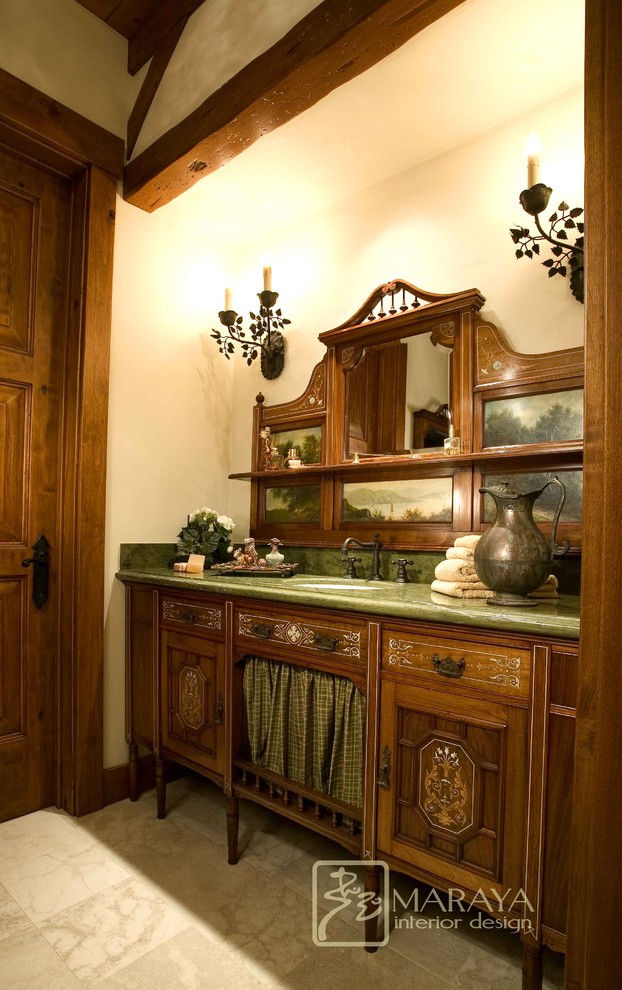 Inspiration for a mid-sized cottage green tile and stone tile limestone floor powder room remodel in Santa Barbara with an undermount sink, furniture-like cabinets, dark wood cabinets, marble countertops, a two-piece toilet and beige walls