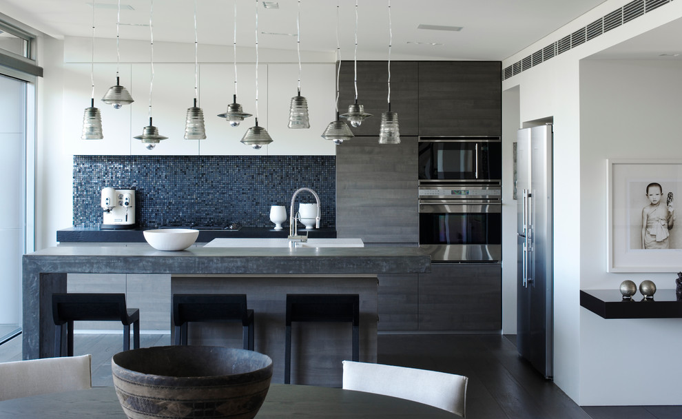 Design ideas for a mid-sized contemporary galley kitchen in Sydney with flat-panel cabinets, stainless steel appliances, with island, blue splashback, mosaic tile splashback, dark hardwood floors and brown floor.